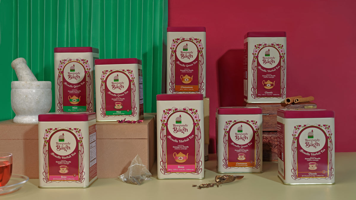 The full Burgundy Bagh roselle tea range on a green and burgundy backdrop