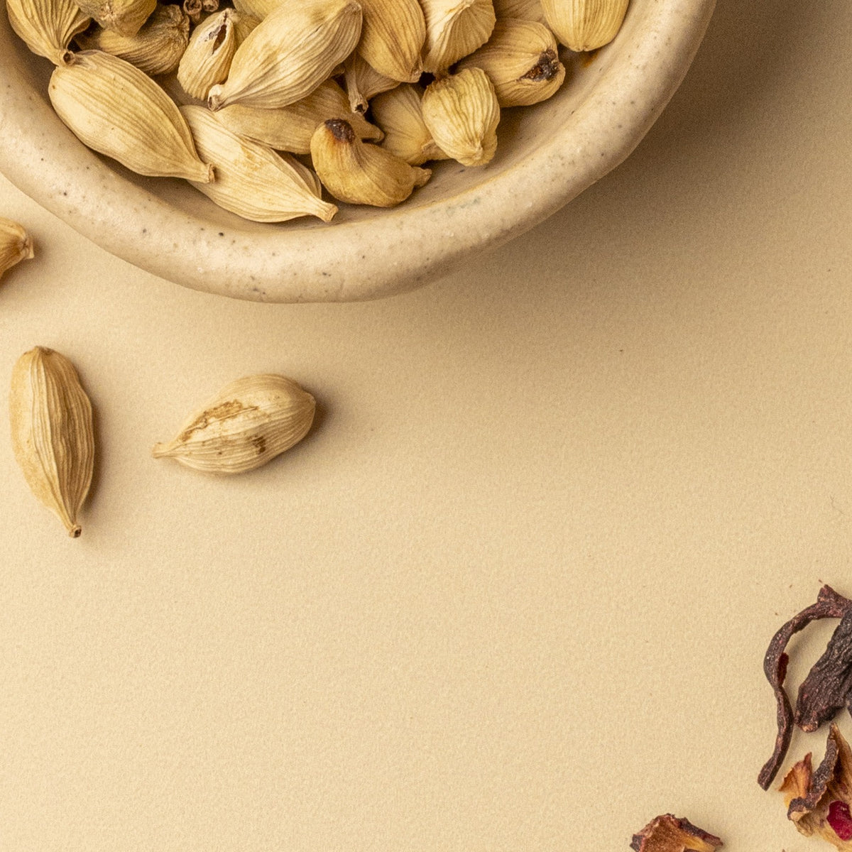 Green cardamom pods in a stone bowl